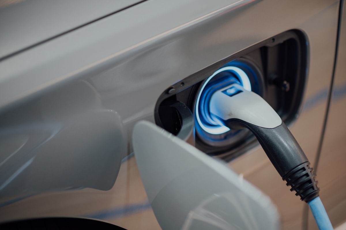 A Level 2 EV charging connector plugged into an electric vehicle charge port