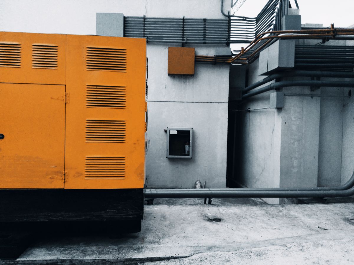 A standby backup generator with its piping and electrical connections